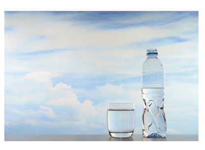 A bottle of water, a water glass, and a gorgeous blue sky.