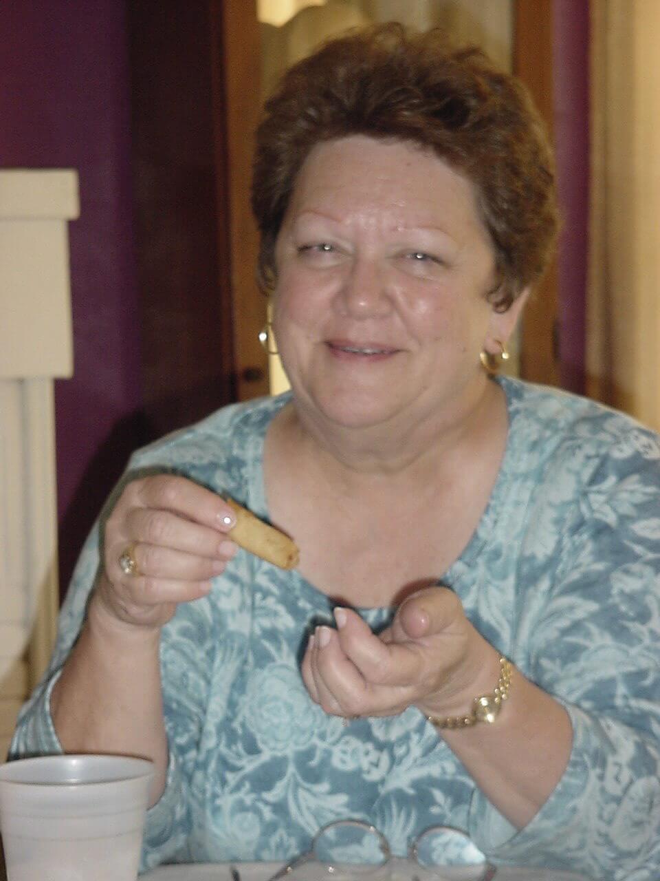 Smiling portrait of a middle-aged woman affected by FXTAS