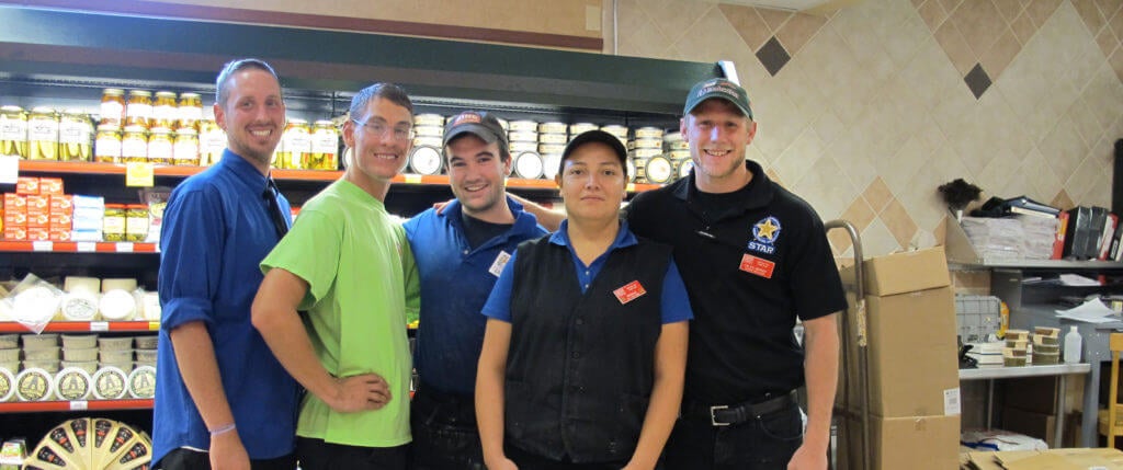 The author's son, Ian, with four of his coworkers at Kroger's grocery store.