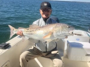 Man holding a large fish in both hands.