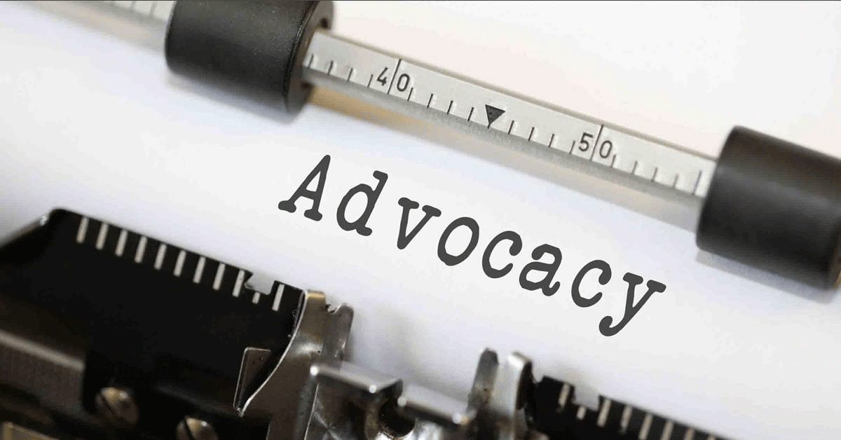 The word Advocacy on a piece of paper in a typewriter.
