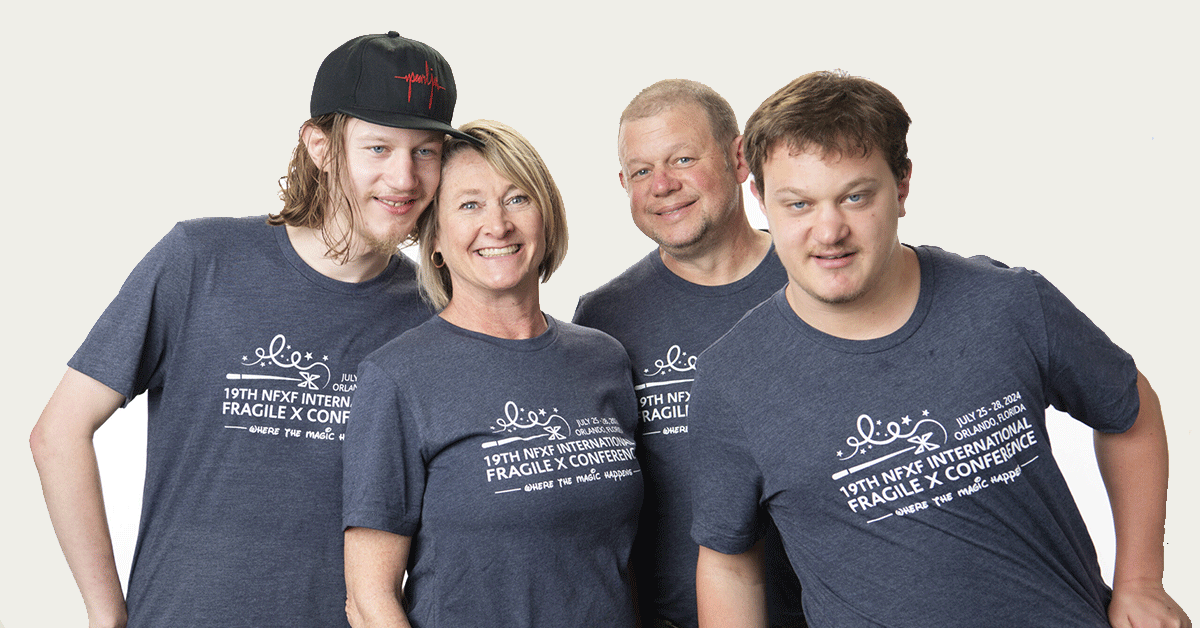 Mom, dad, and their two sons wearing International Fragile X Conference t-shirts.