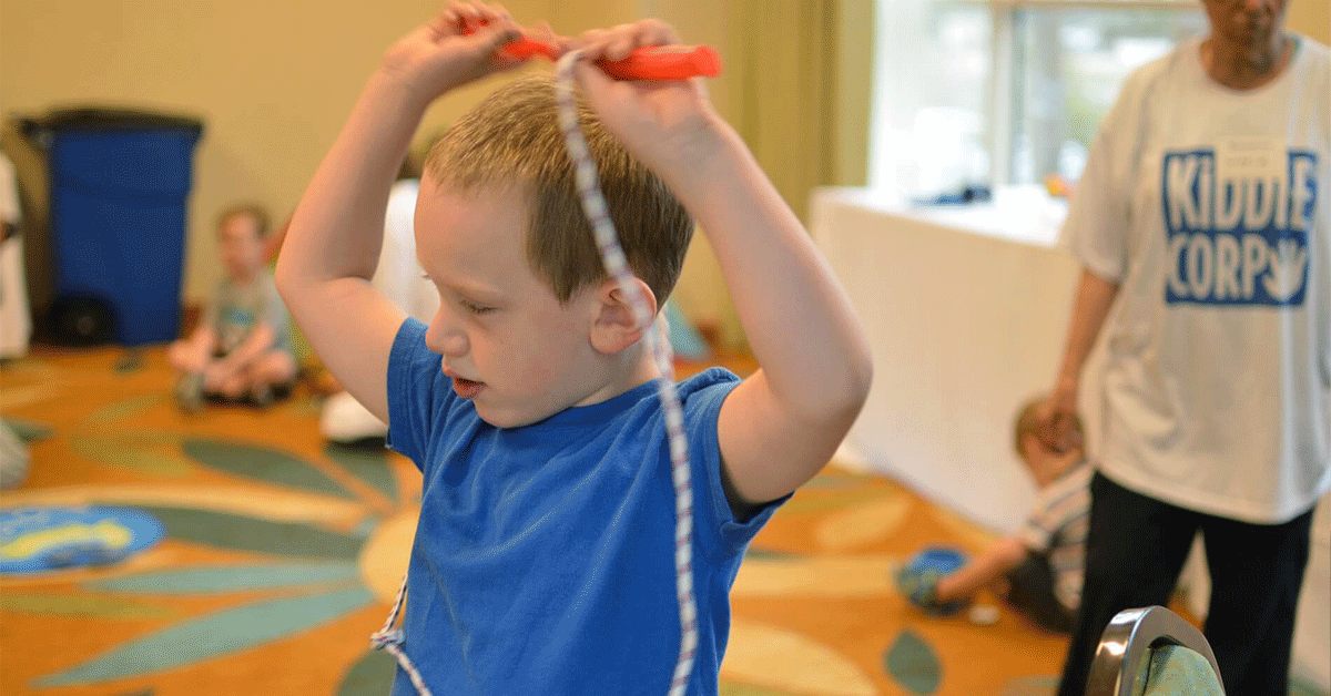 I child in a classroom playing with a jump rope.