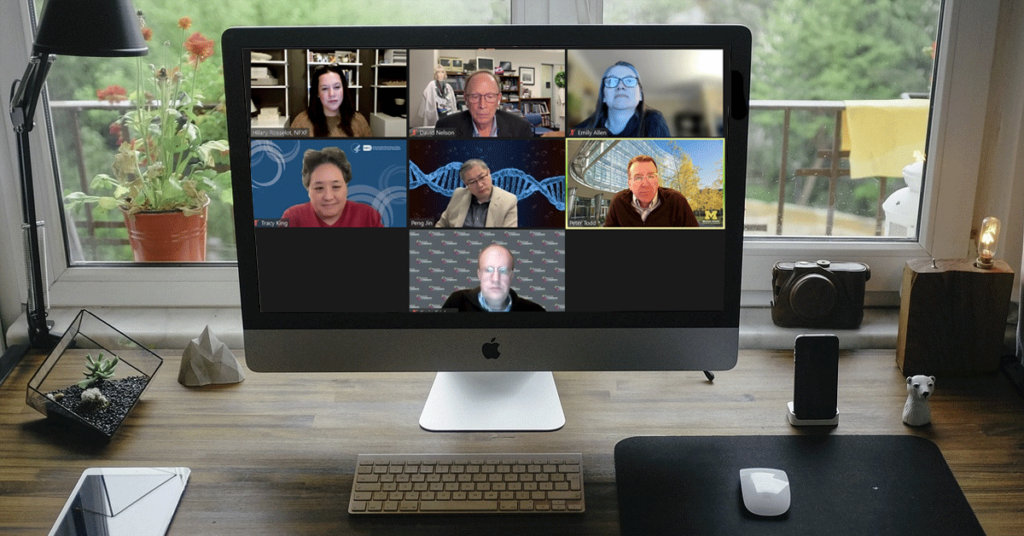 Webinar appearing on a computer screen on a person' desk.