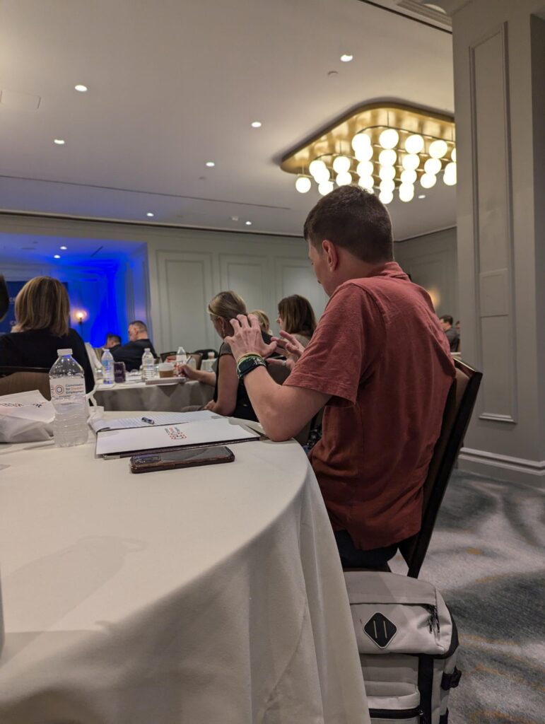 Dillon Kelly listening to a presentation.