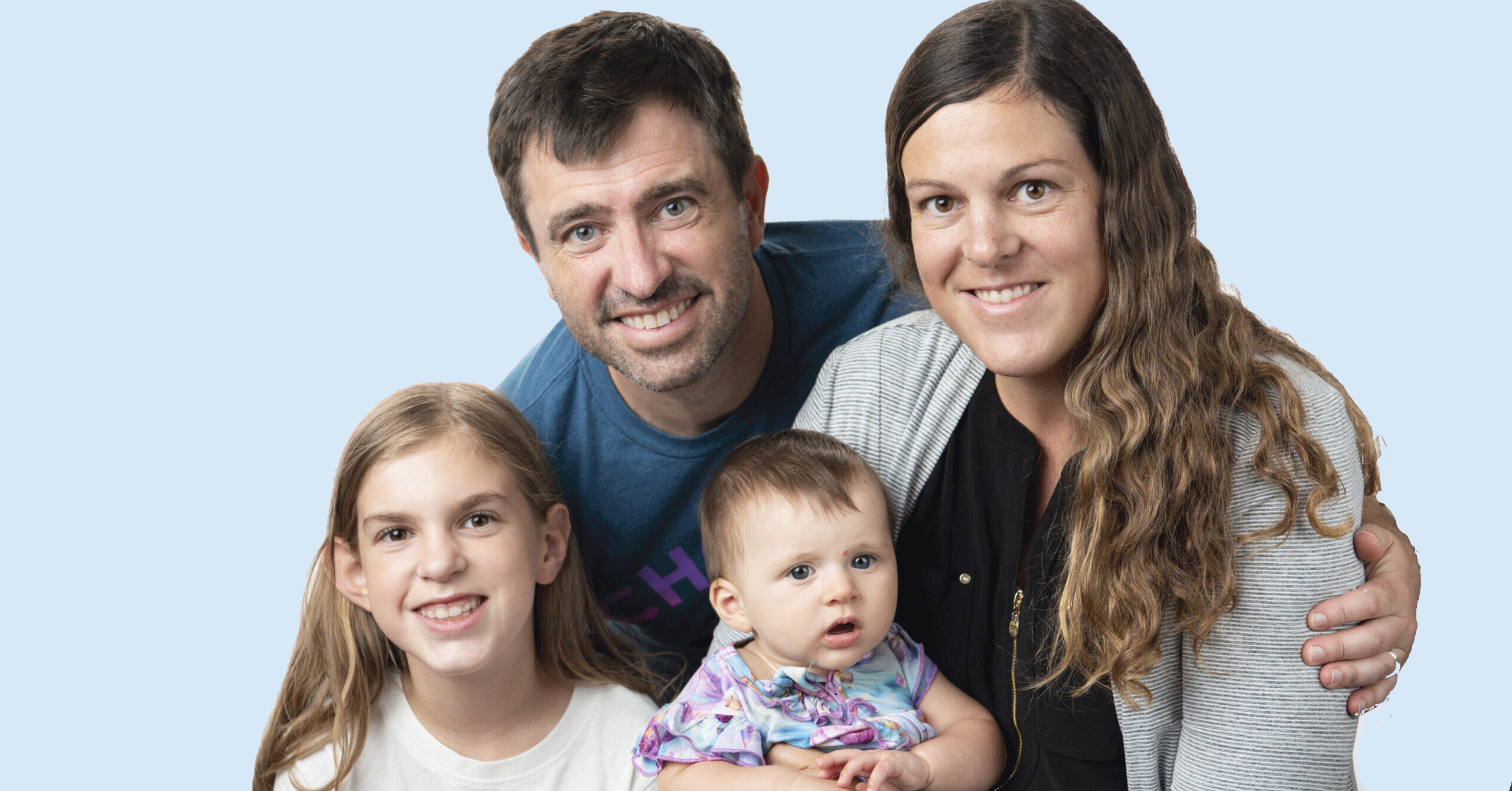 A family with a dad, mom, young daughter, and an infant.