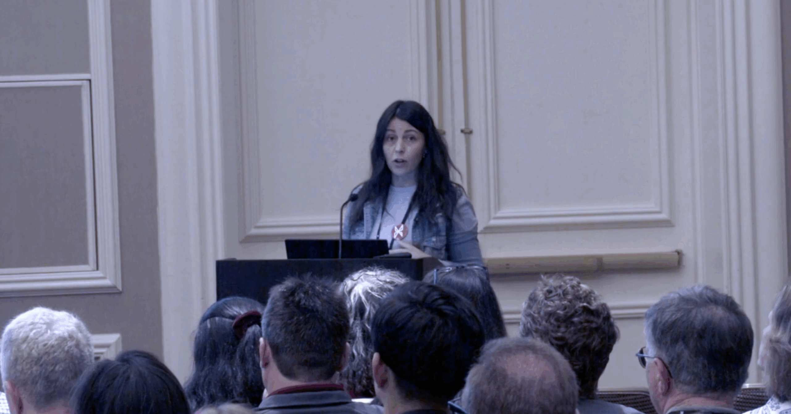 Presenter Amie Milunovich speaking at a podium