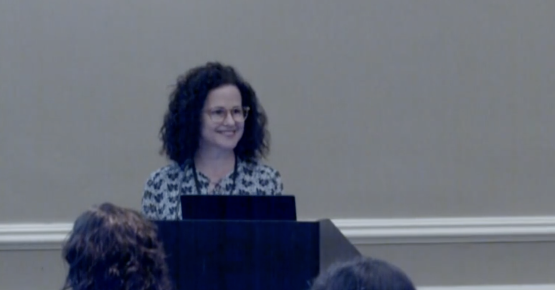 Dr Deby Barbouth at podium