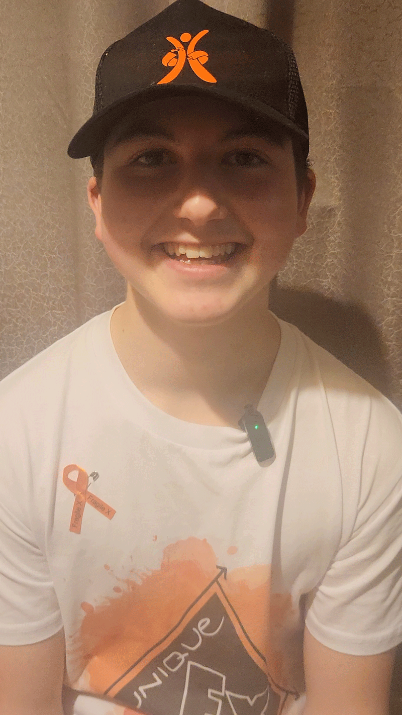 Oliver Casey wearing a baseball hat and big happy smile.