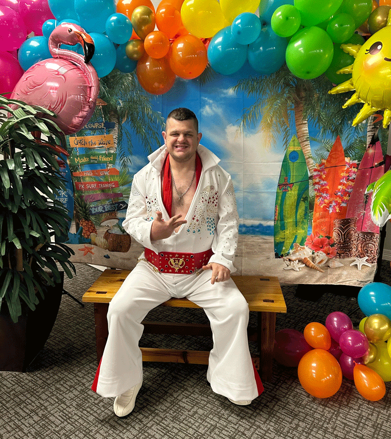 Keith Hampton wearing an Elvis costume and giving a big thumbs up.