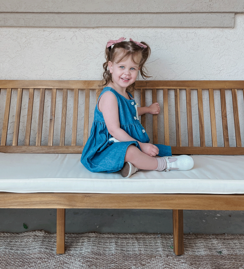Elsie sitting on a bench looking cute as a button.