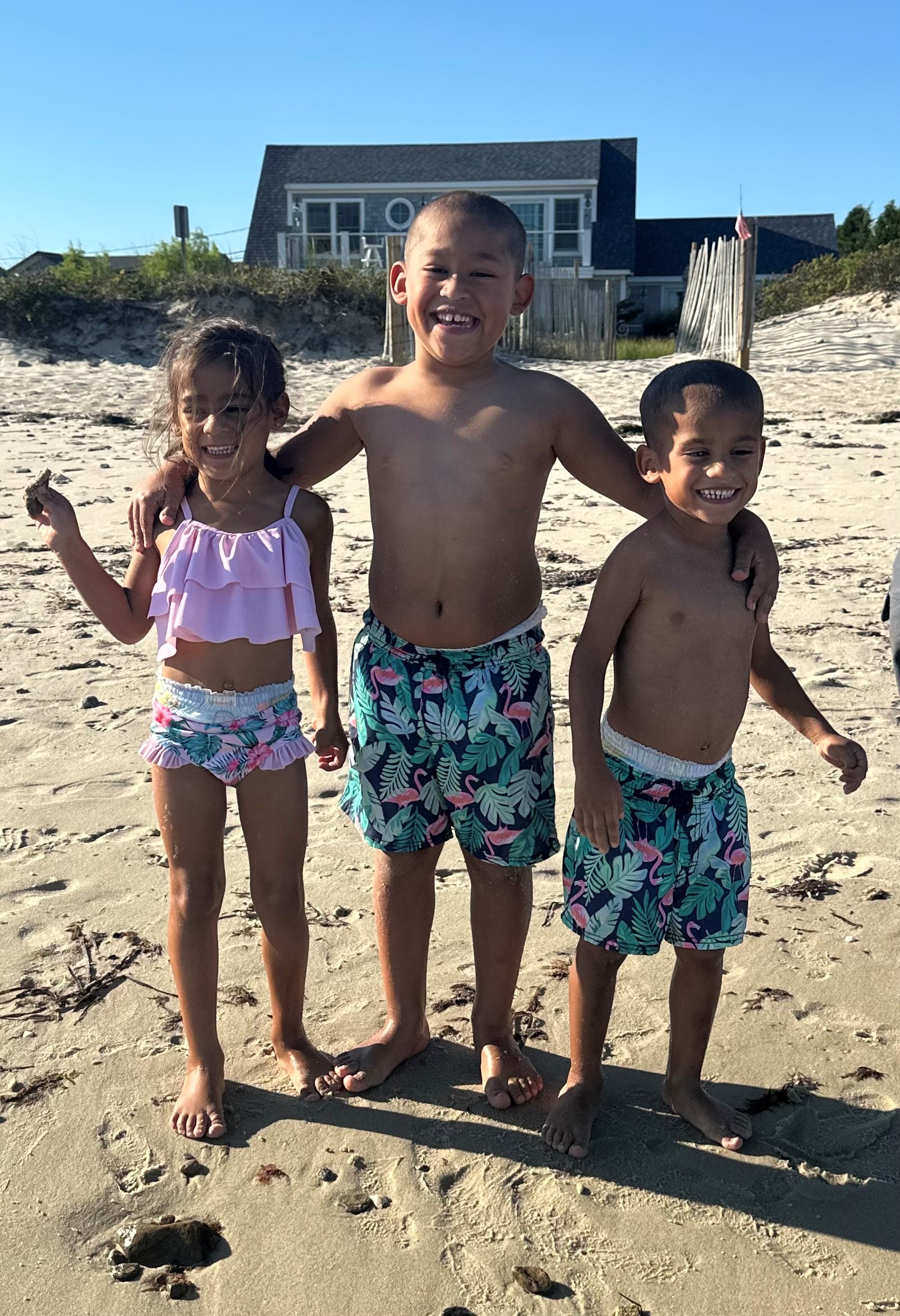 Three young children on the beach