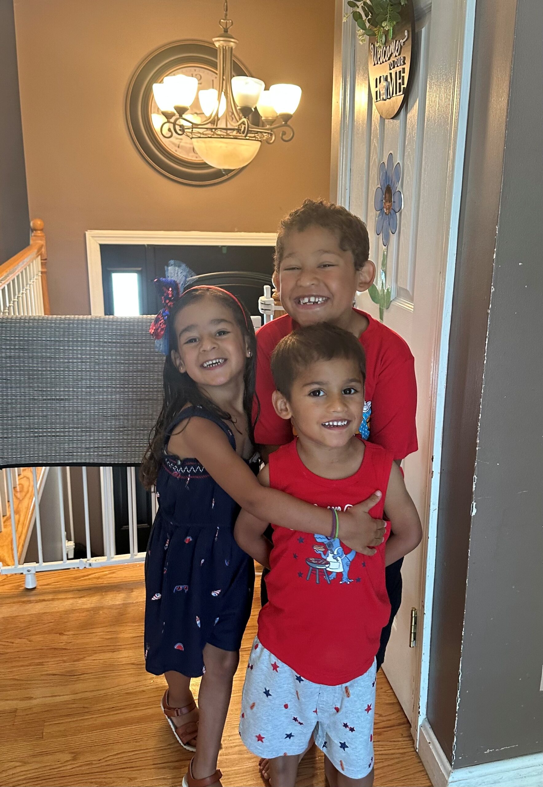 Three young children dressed in red, white, and blue.