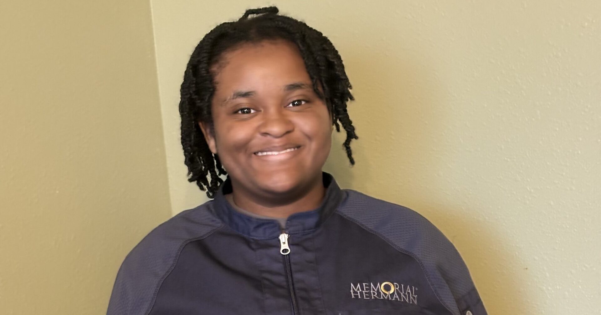 Young woman wearing uniform smiling