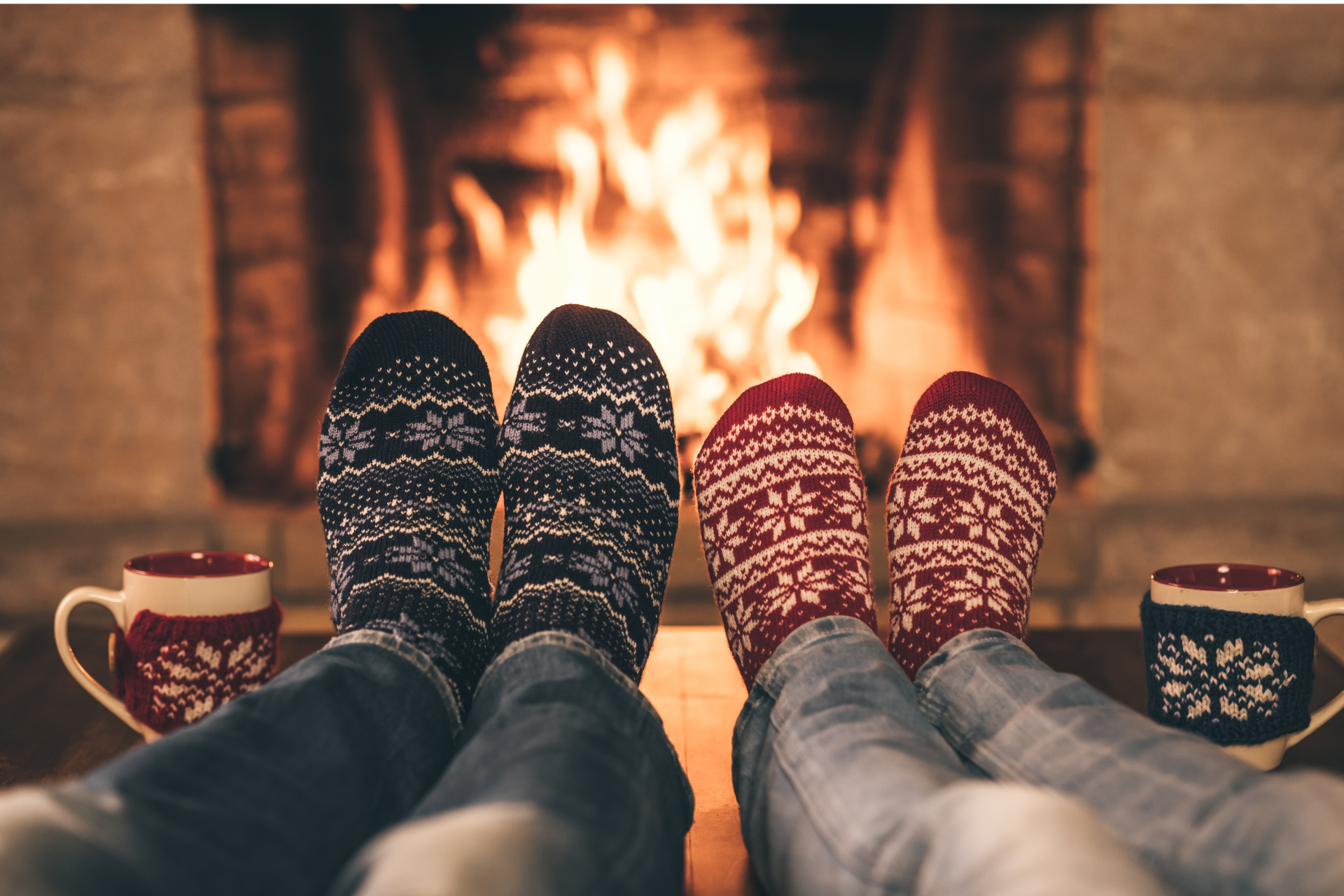 Two people sitting in front of a fire with cozy socks