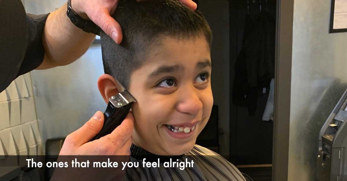 A young boy with FXS getting a haircut.