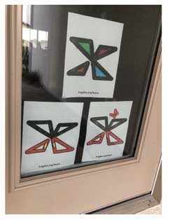 Fragile X logo X in a door window.