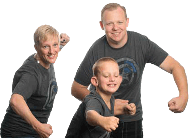 A mom, dad, and son posing with fists clenched and smiling