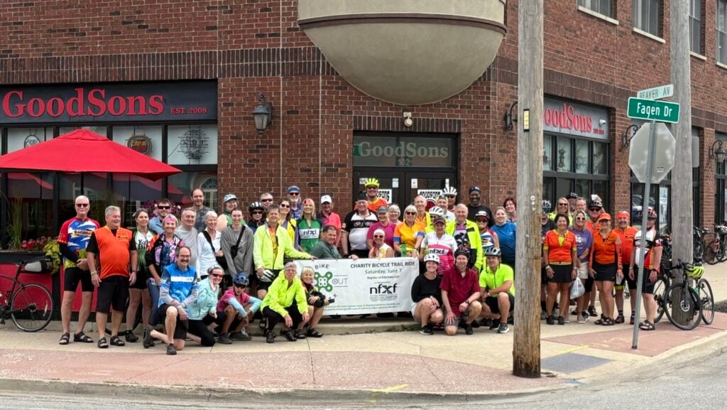 2025 Bike to X Out – featured Ride to X Out Fragile X even organizers in front of GoodSons bar with an event banner.