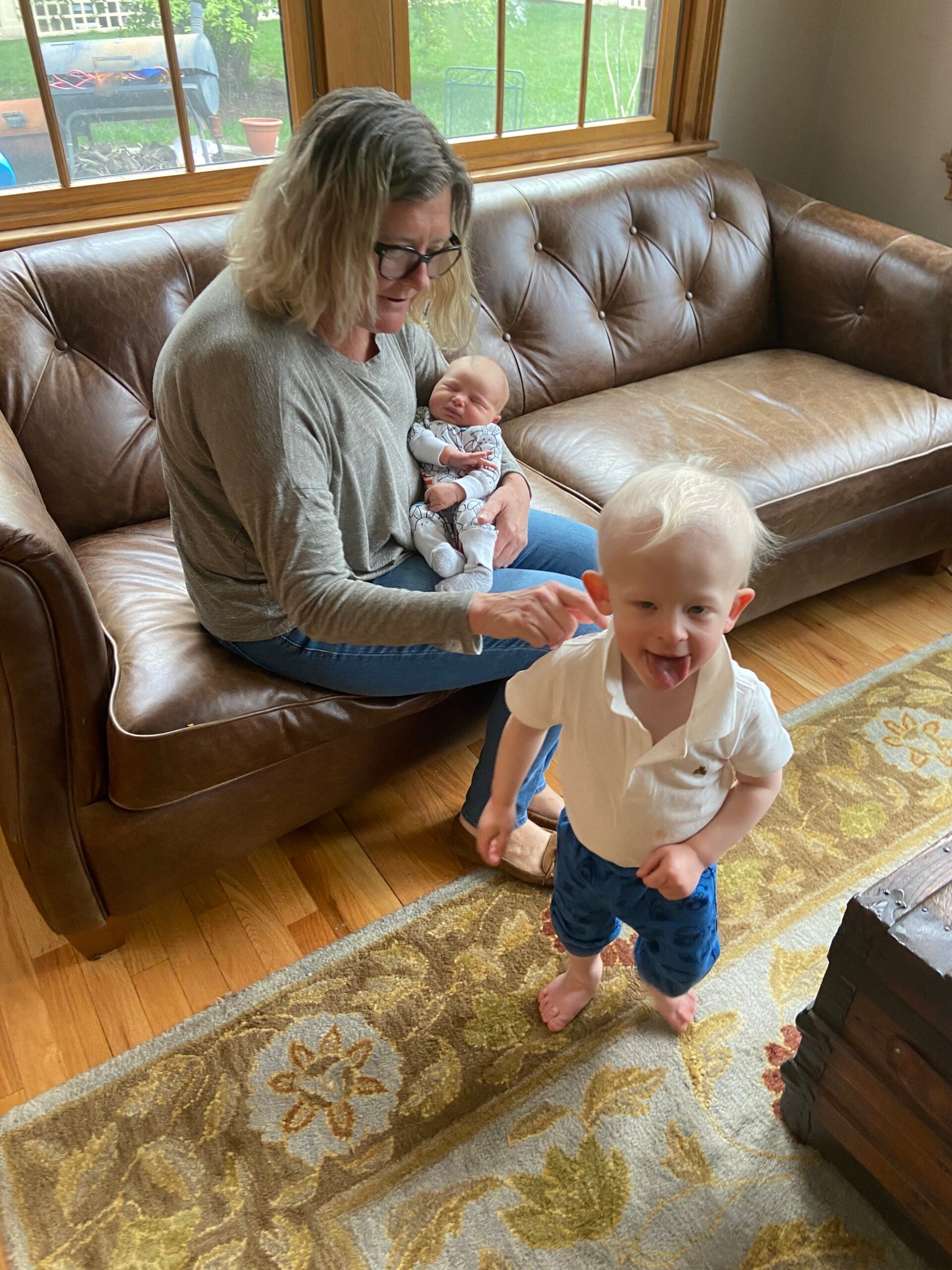 Grandma and grandsons riding in a gold cart.