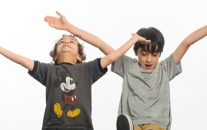 Two boys with Fragile X syndrome raising their hands