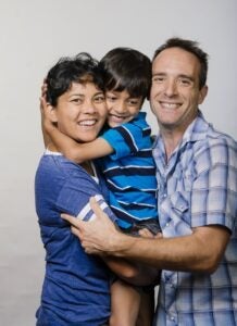 A young boy and girl hugging and smiling