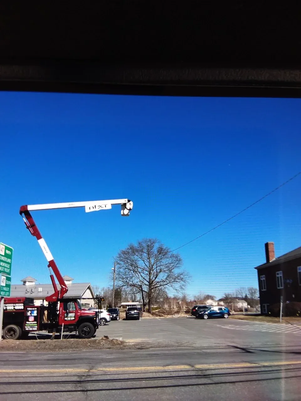 A crane with a NFXF sign hanging from the top