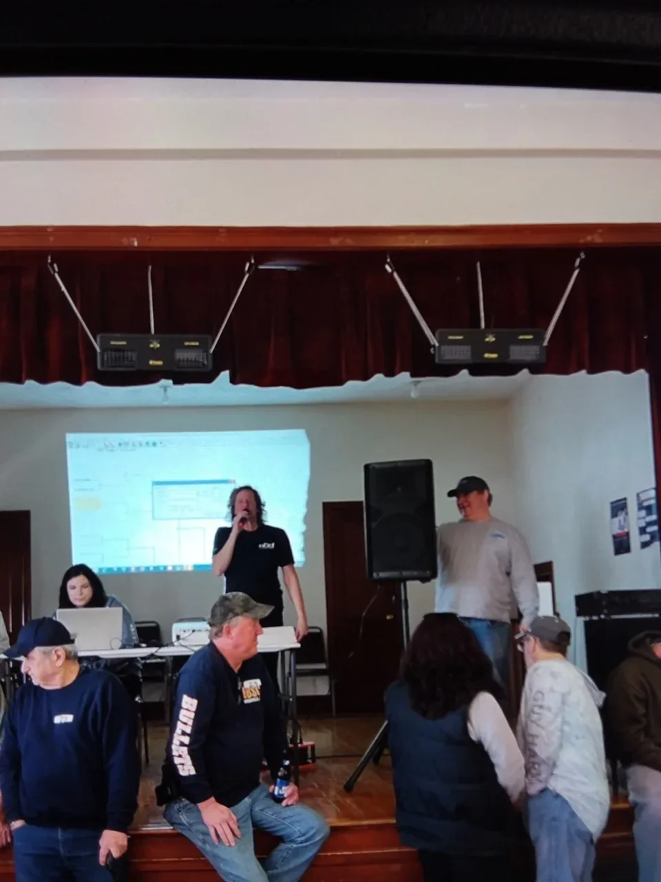 Man talking into a microphone making a presentation