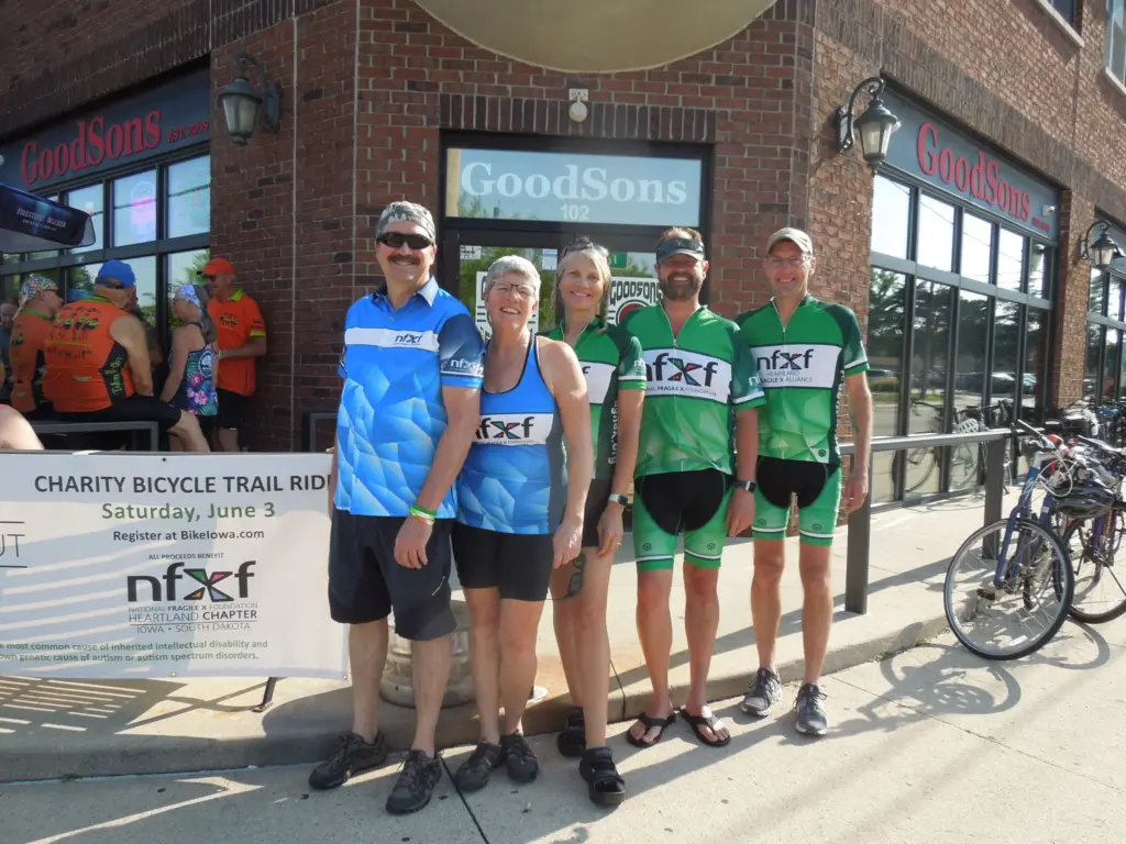 Chapter members display a sign promoting their annual Fragile X bike ride and fundraising event.