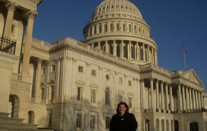 Woman standing in front of the US Capitol