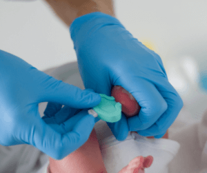 newborn receiving a heel prick blood test
