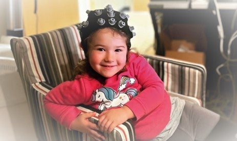 Girl smiling with EEG cap on her head