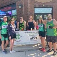 Nancy Carlson and other riders in the Heartland chapter Bike To X Out Fragile X fundraising event outside of Exile Brewing Co. in Des Moines, Iowa.