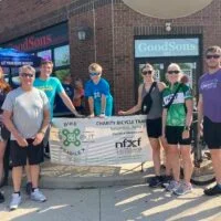 Nancy Carlson and other riders in the Heartland chapter Bike To X Out Fragile X fundraising event outside of GoodSons market in Des Moines, Iowa.