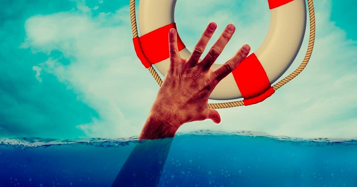 Hand reaching out from the water for a life raft