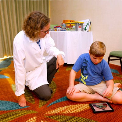 Clinician assessing young boy at a clinic