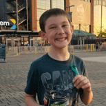 Young boy standing outside a large conference center