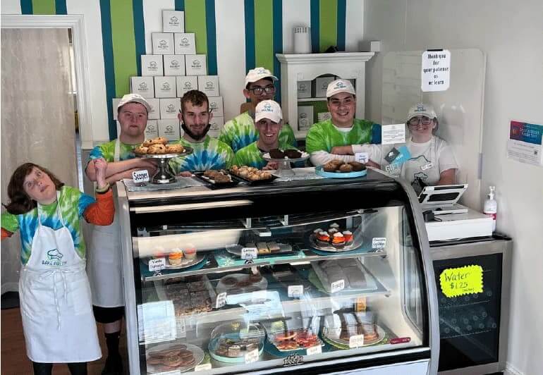 Bake Ability employees standing around display case