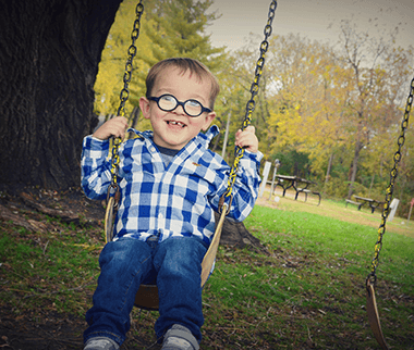 Young boy on a tree swing