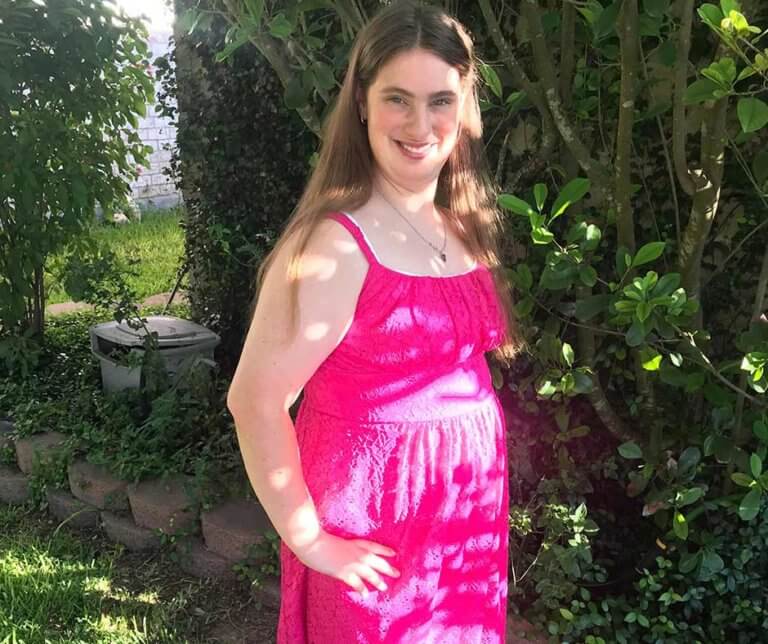 Caragan outdoors in a bright pink dress