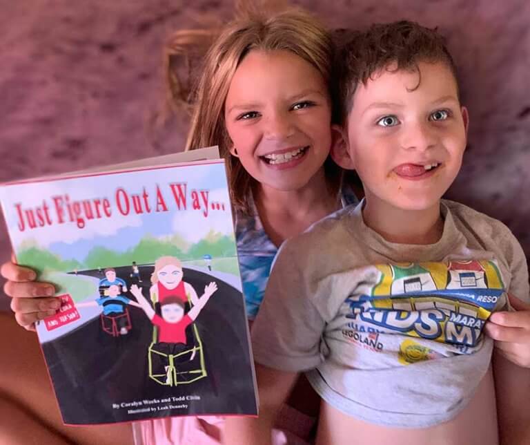 Coralyn with her brother Rikson, and holding her book "Just Figure Out a Way"