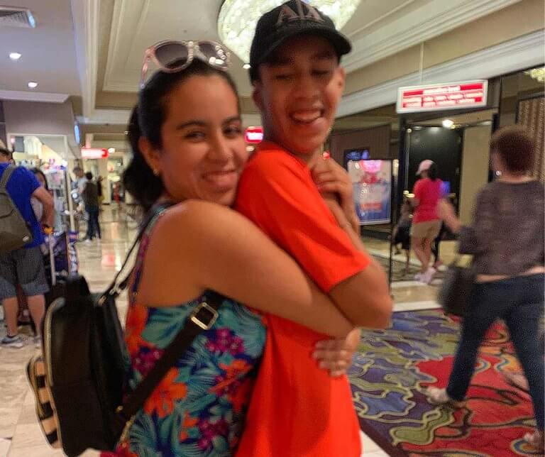 Dalia and Jonathan hugging in a shopping mall.