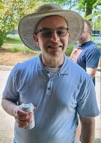 David Fishman outdoors drinking a soda.