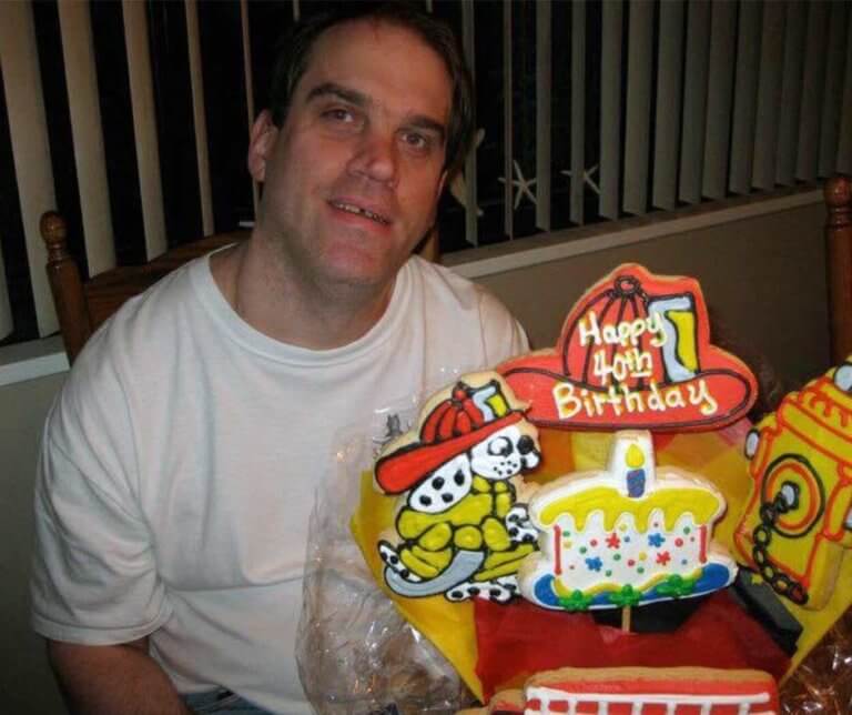 Dougie McBride sitting in front of his birthday cake.