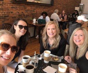 Shawna, Tara, Samantha, and their mom, Cheryl, having coffee in a cafe.