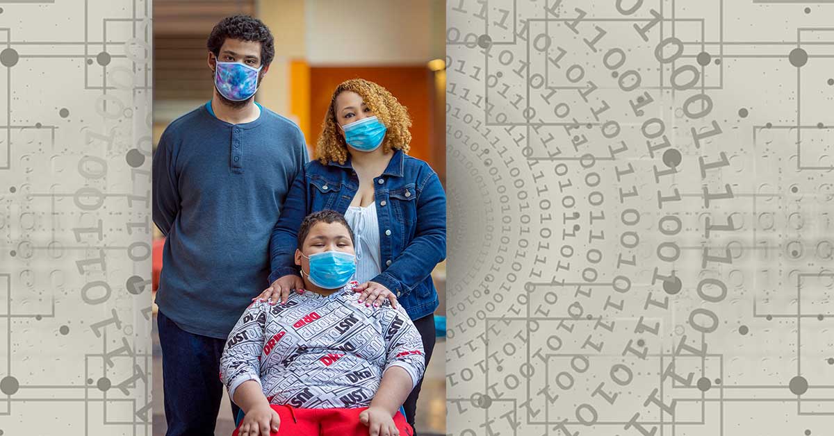 Mom, dad, and son in a wheelchair, all wearing medical masks.