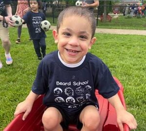 Giorgio in shorts and a t-shirt on the playground.