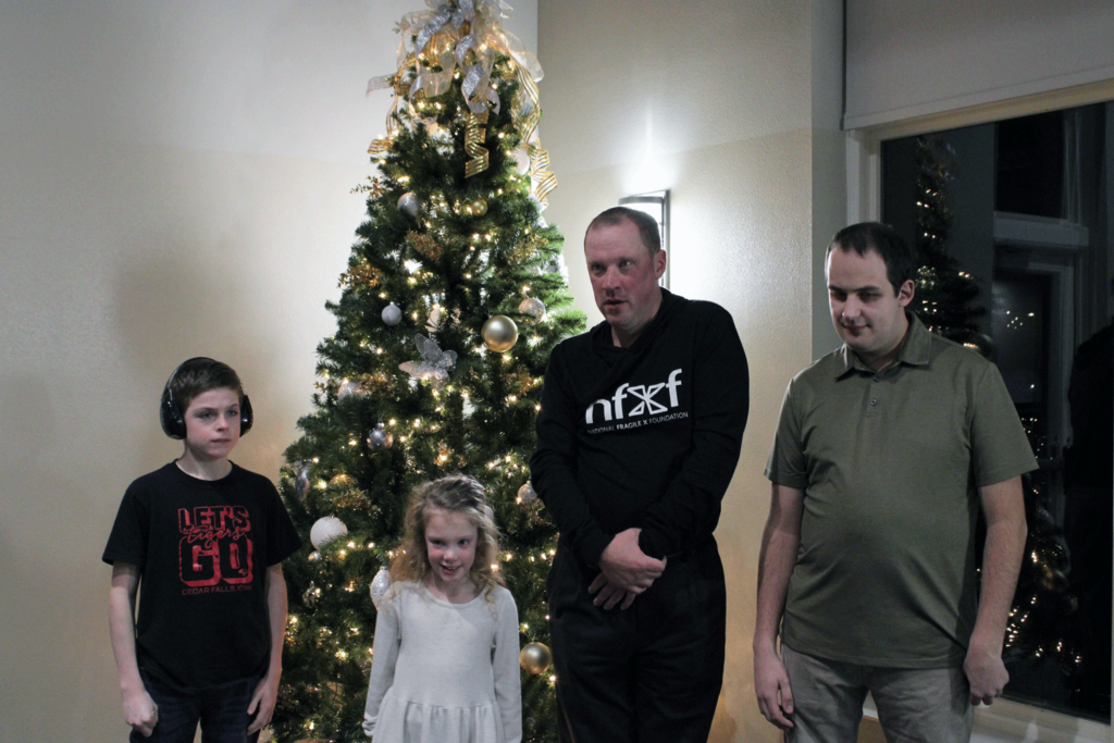 Brady, Nellie, Aaron, and Colton by the Christmas tree.