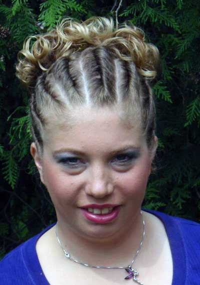 Hannah Grable, a beautiful young woman with Fragile X syndrome, wearing a dark purple shirt and her golden hair in a fancy updo.