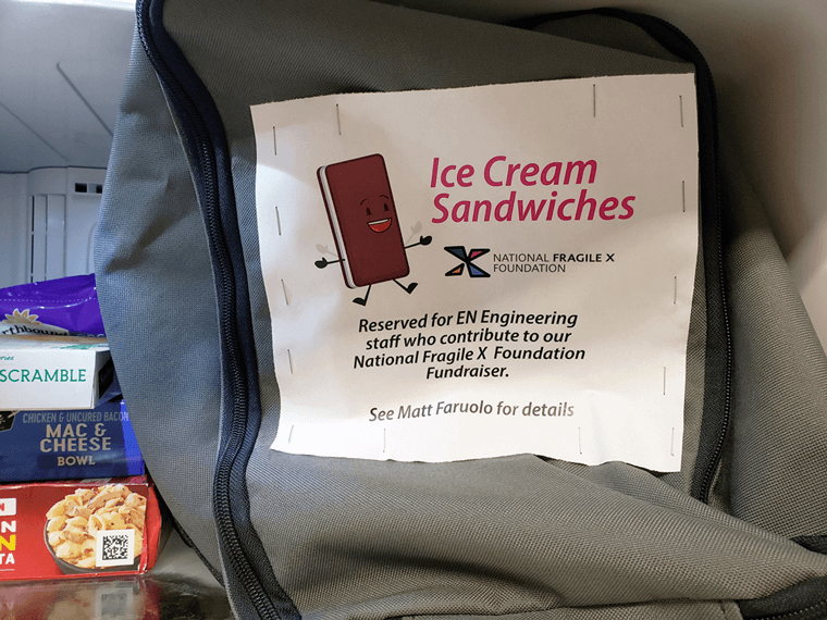 Inside of freezer with bag of ice cream sandwiches and a sign